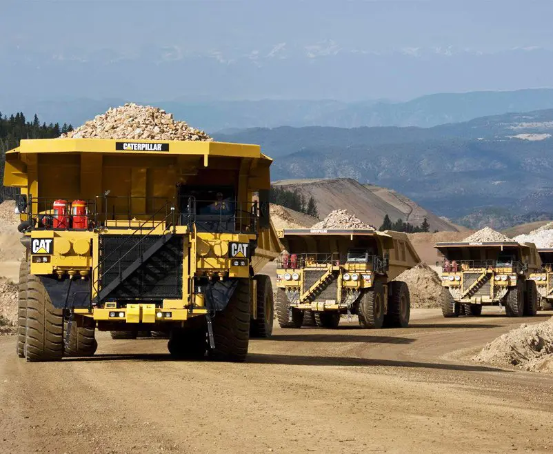 A large dump truck driving down the road.